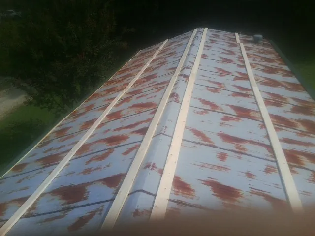 Rusted metal roof panels with new wood purlins before replacement — Storm Damage Roof Repair in Teasdale by Roofing Brothers